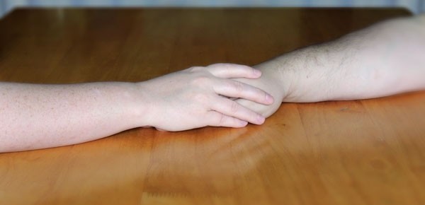 Psychic Counseling: Bernadette hold a clients hand.
