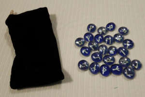 White on blue Runes with black stretch-velvet pouch.
